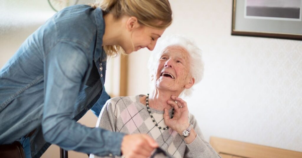 senior woman smiling and receiving help
